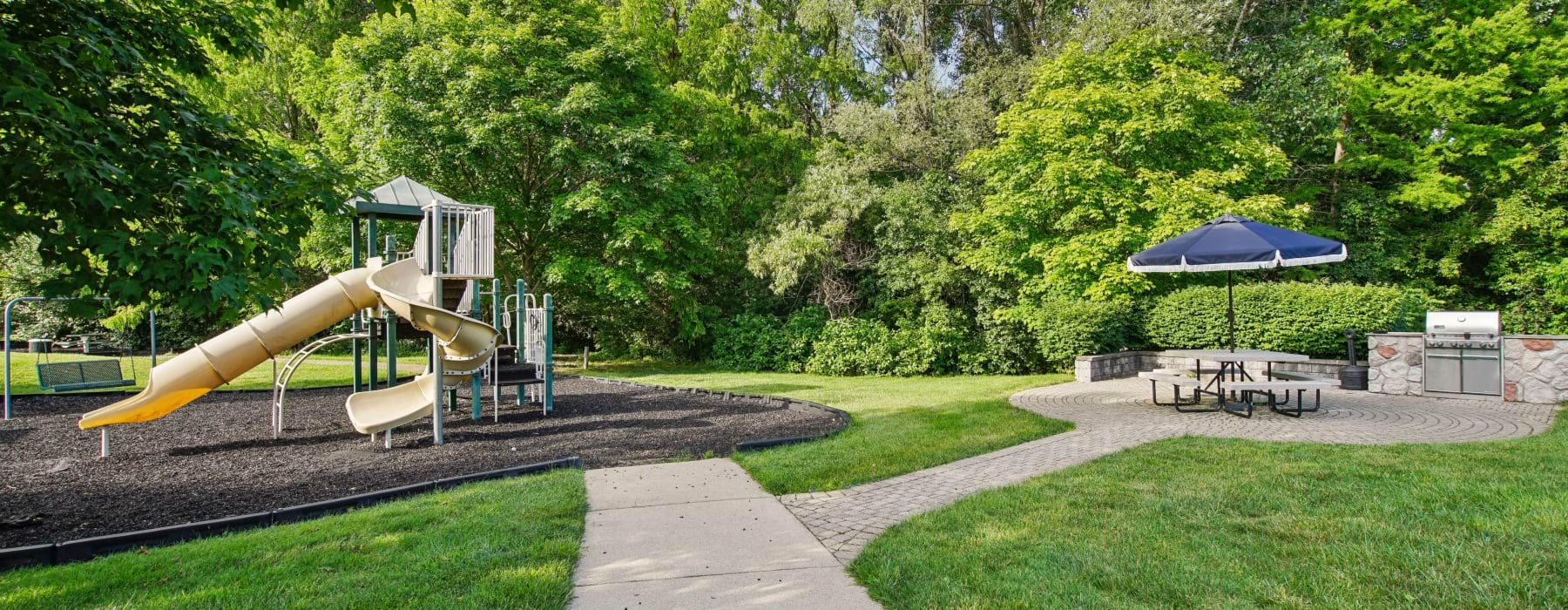 Outdoor grill and table at The Graham Apartments