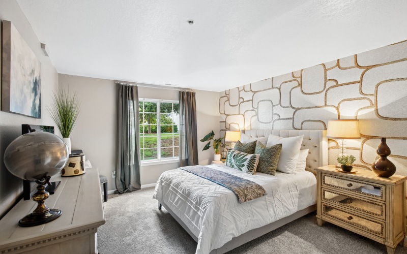 bedroom with large window and bed